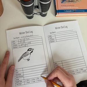 May include: A black and white drawing of a chickadee bird on a white page with a bird log checklist. The checklist includes sections for date, time, location, weather, size, color, markings, male/female, song, beak type, and tail type.