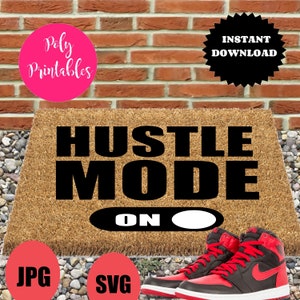 May include: A brown doormat with the text "Hustle Mode On" in black lettering. The text "On" is displayed as a toggle switch with a white circle on the right side of the switch.