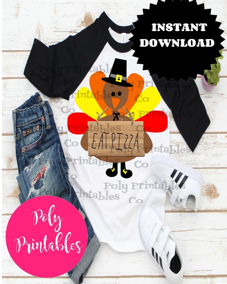 May include: A white t-shirt with a black and white baseball style sleeve design. The shirt features a cartoon turkey wearing a pilgrim hat and holding a sign that says "Eat Pizza".