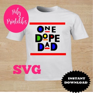 May include: White t-shirt with the text "ONE DOPE DAD" in black letters with colorful accents. The text is framed by two red lines.
