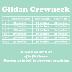 May include: A light green graphic with the words "Gildan Crewneck" at the top. Below is a table with measurements for full body length, sleeve length, and body width in inches for sizes S through 3XL. The text also includes "unisex adult 8 oz -50/50 fleece -Screen printed to prevent cracking."