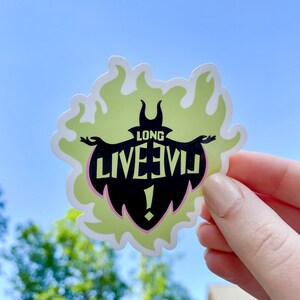 May include: A green and black sticker with a silhouette of Maleficent from Disney's Sleeping Beauty. The sticker has the text "Long Live Evil!" in black and white.