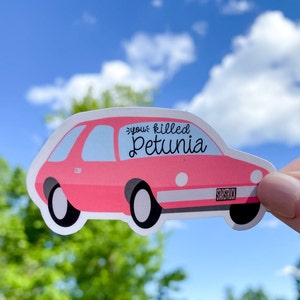 May include: Pink car sticker with the text "You killed Petunia" and the word "Starstruck" on the license plate.