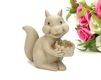 Squirrel figurine with a basket in its paws