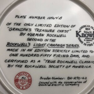 May include: A white ceramic plate with black text on the back. The text reads "Plate Number 10564 B of the only limited edition of "Grandpa's Treasure Chest" by Norman Rockwell Second in the Rockwell's Light Campaign Series. Made in an edition strictly limited to one hundred fifty firing days, and certified as a "True Rockwell Classic" by the Rockwell Society of America. Bradex Number: 84-R70-6.2 Issued with the cooperation of General Electric Company."