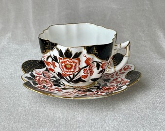 Hand decorated Porcelain cup and matching plate made in England
