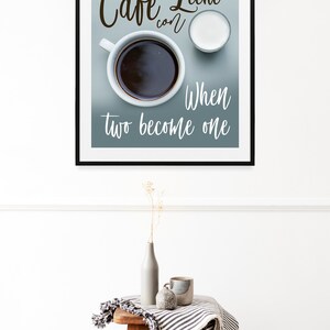 May include: A framed print with a blue background featuring a cup of coffee and a small pitcher of milk. The text reads "Cafe Leche con" and "When two become one".