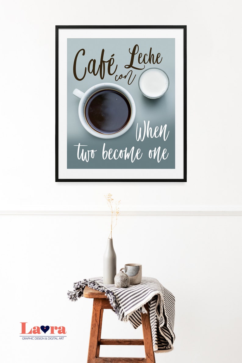 May include: A framed print with a blue background featuring a cup of coffee and a small pitcher of milk. The text reads "Cafe Leche con" and "When two become one".