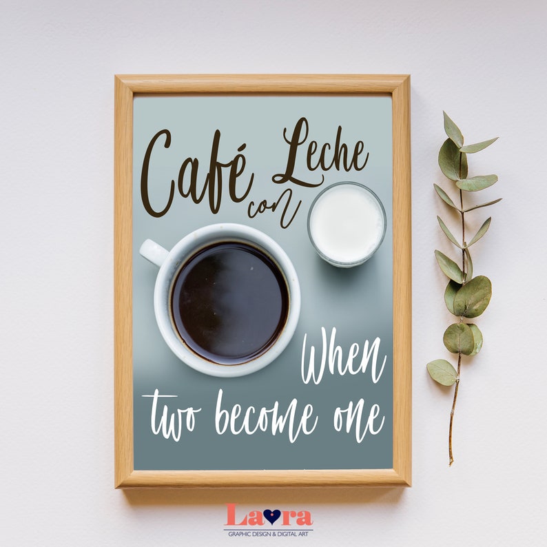 May include: A framed print with a blue background and white text that reads "Cafe Leche con When two become one". The print features a cup of coffee and a small glass of milk.