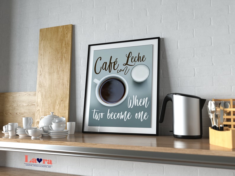 May include: A framed print with a blue background and white text that reads "Cafe con Leche When two become one". The print features a cup of coffee and a small bowl of milk.