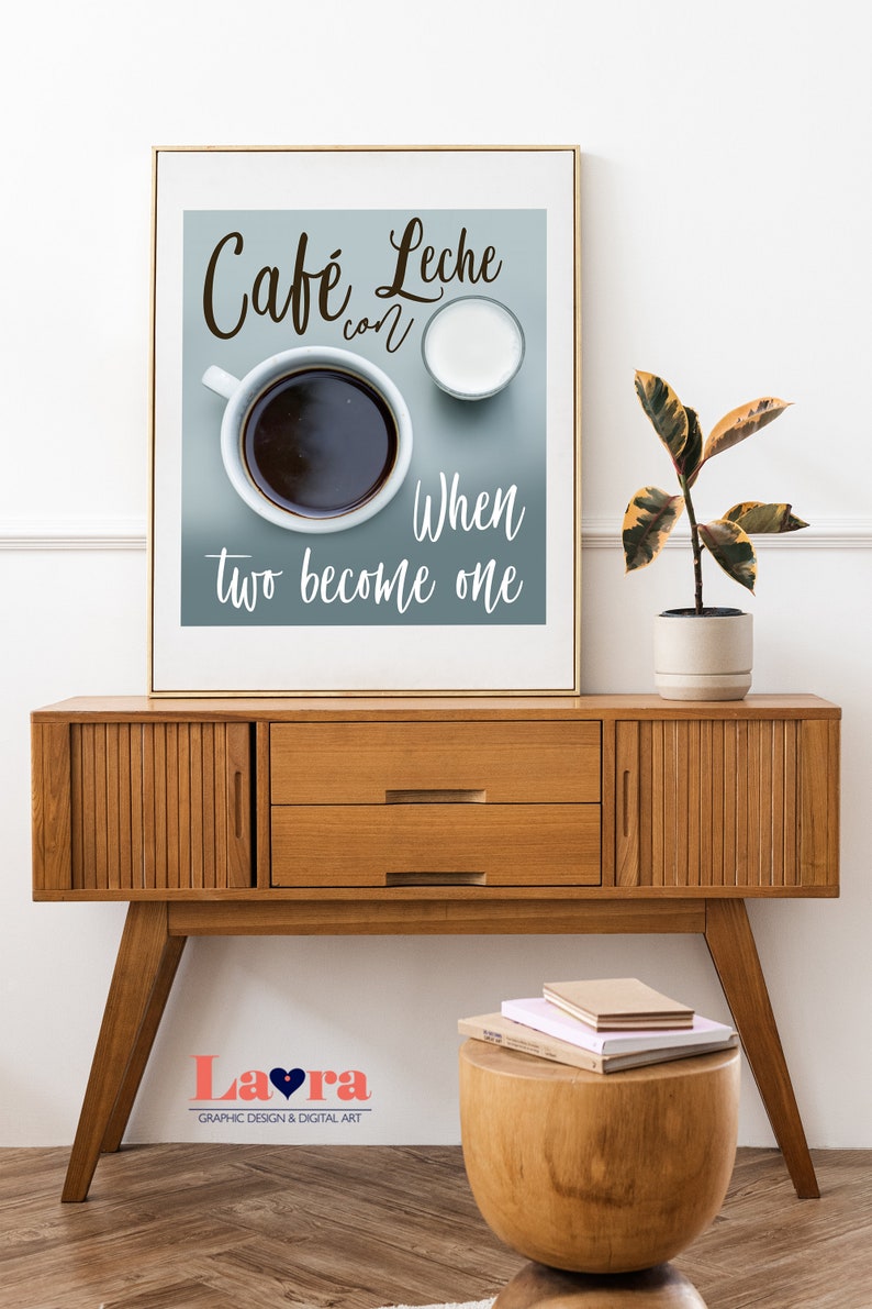 May include: A framed print with a blue background featuring a cup of coffee and a small pitcher of milk. The text reads "Cafe Leche con When two become one".