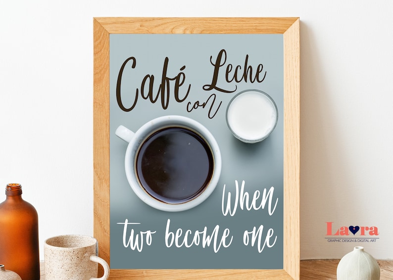 May include: A framed print with a blue background featuring a cup of coffee and a small glass of milk. The text "Cafe con Leche" is written in cursive at the top of the print. Below the coffee and milk, the text "When two become one" is written in cursive.