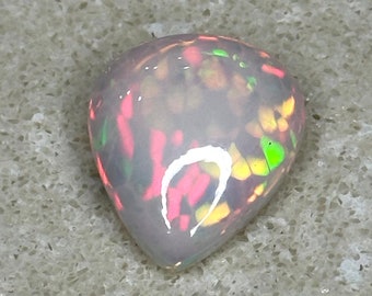 May include: A teardrop-shaped opal gemstone with a white base and a colorful pattern of green, pink, and yellow.