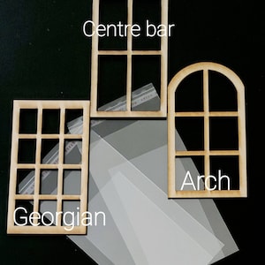 May include: Three light brown wooden window frames with clear plastic sheets. The frames are labeled Centre bar, Georgian, and Arch. The Georgian frame has twelve panes, the Centre bar has four panes, and the Arch frame has a rounded top with four panes.
