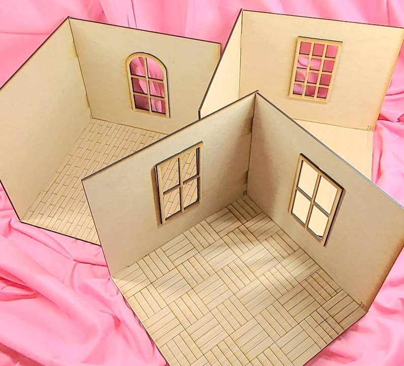 May include: Three unfinished wooden dollhouse room dioramas featuring light-colored plywood walls and floors. Each room has distinct window designs, including arched and rectangular frames, and various floor patterns like brick and parquet styles.