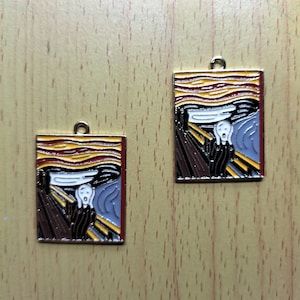 May include: Two gold-colored metal charms featuring a painting of "The Scream" by Edvard Munch. The charms are square and have a yellow, red, blue, and black color scheme.