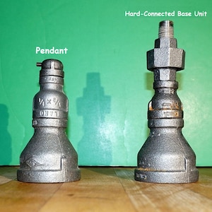 May include: Two silver metal pipe fittings, one labeled "Pendant" and the other labeled "Hard-Connected Base Unit".