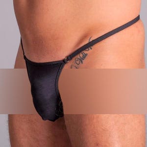 May include: Black lace thong underwear with a thin strap design. The underwear has a ribbed texture.