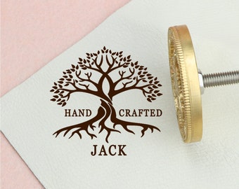 May include: A brass stamp with a tree design and the words "HAND CRAFTED JACK".