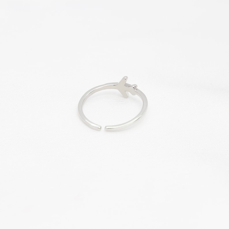 Op de afbeelding: Een zilveren vliegtuigring met een eenvoudig ontwerp. De ring is open en verstelbaar.