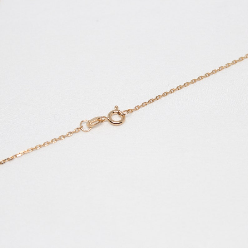 May include: A gold chain necklace with a lobster clasp closure.