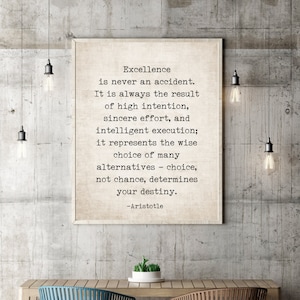 May include: A motivational quote by Aristotle printed on a beige background in a black frame. The quote reads: "Excellence is never an accident. It is always the result of high intention, sincere effort, and intelligent execution; it represents the wise choice of many alternatives - choice, not chance, determines your destiny."
