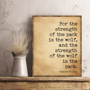 May include: A vintage-style print with a quote by Rudyard Kipling: "For the strength of the pack is the wolf, and the strength of the wolf is the pack."