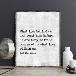 May include: Framed print with a textured, off-white background featuring a quote by Ralph Waldo Emerson: "What lies behind us and what lies before us are tiny matters compared to what lies within us."