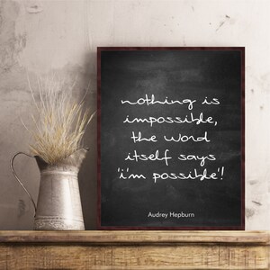 May include: Black chalkboard with white text that reads "nothing is impossible, the word itself says 'i'm possible!'". The quote is attributed to Audrey Hepburn at the bottom of the chalkboard.