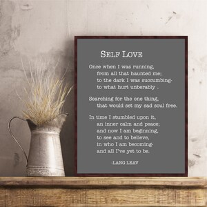 May include: A framed print with a gray background and white text. The text is a poem titled "Self Love" by Lang Leav. The poem is about finding inner peace and self-acceptance.