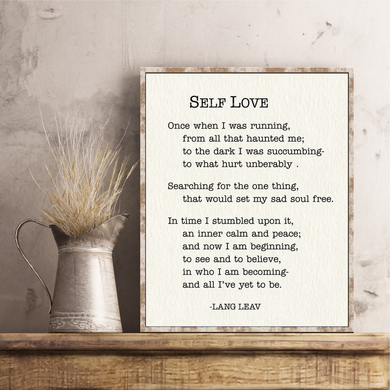 May include: A framed print with a beige background and black text. The text is a poem titled "Self Love" by Lang Leav. The poem is about finding inner peace and self-acceptance.