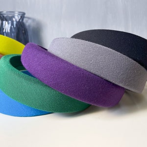 May include: A set of six colorful fabric headbands in various shades of blue, green, purple, gray, pink, and yellow. The headbands are made of a soft, stretchy fabric and are designed to be comfortable to wear.