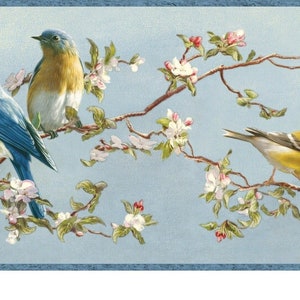 May include: Three birds perched on a branch with white blossoms. Two bluebirds with yellow breasts and a yellow bird with black stripes on its wings.