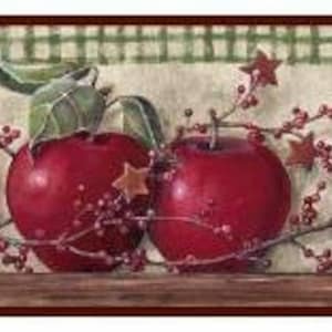 May include: Red apples with green leaves and red berries on a white and green checkered background. The apples are arranged in a row with the stems facing up. The background is a light brown color.