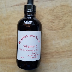 May include: A dark brown glass bottle with a dropper top. The label reads "Herbs and Such Vitamin C Take one dropper a day Ingre: Water, glycerin Rosehip 4 oz"