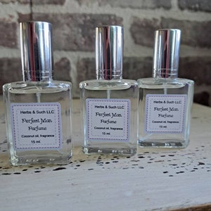 May include: Three clear glass perfume bottles with silver caps. Each bottle has a white label with the text "Herbs & Such LLC, Perfect Man Parfume, Coconut oil, fragrance, 15 ml."