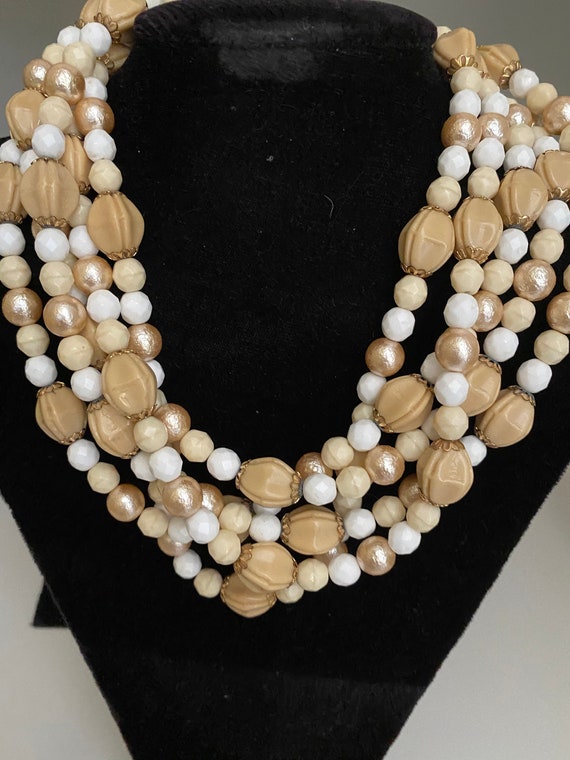 White, beige, gold 5-strand 19 inch necklace.  Per