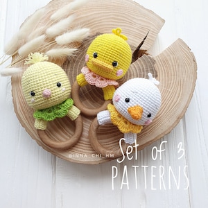 May include: Set of three crochet chick rattle patterns. Each chick is crocheted with different colored yarn and has a wooden ring. The text "Set of 3 Patterns" is visible in the image.