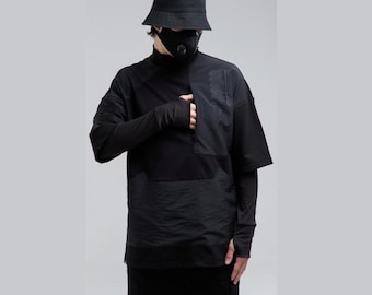 May include: Black layered top with short sleeves and a high collar, paired with black pants and a bucket hat. The top features a textured panel on the front and long sleeves with fingerless gloves. A black face mask is also worn.