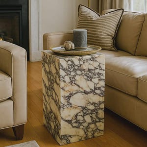 May include: A set of three ceramic mugs with a speckled, matte finish. The mugs are in shades of cream, light gray, and dark gray. Each mug has a simple, minimalist design, perfect for coffee or tea.