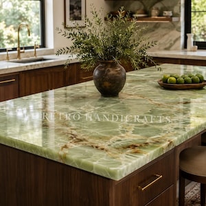 May include: A polished light green onyx countertop with white and brown veining, featuring a dark brown ceramic vase filled with green foliage and a wooden bowl containing green limes, with the text RETRO HANDICRAFTS visible.
