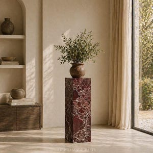 May include: A tall, rectangular marble pedestal with a rich burgundy and white veined pattern. A brown ceramic vase filled with green foliage sits atop the pedestal. The text "RETRO HANDICRAFTS" is at the bottom.