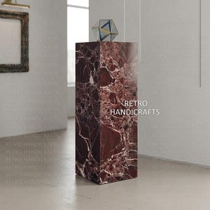 May include: A rectangular marble pedestal with a geometric glass sculpture on top. The pedestal is a deep burgundy color with white veining. The text "RETRO HANDICRAFTS" is visible on the pedestal.