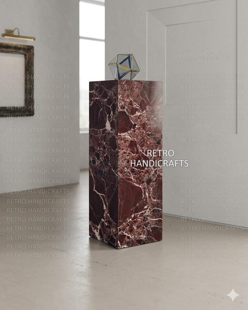 May include: A rectangular marble pedestal with a geometric glass sculpture on top. The pedestal is a deep burgundy color with white veining. The text "RETRO HANDICRAFTS" is visible on the pedestal.