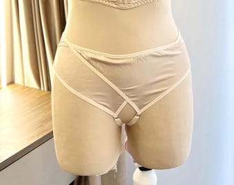 May include: Beige lingerie with a criss-cross design and a sheer panel in the front.