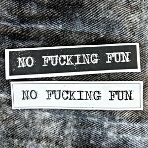 May include: Two rectangular stickers featuring the text NO FUCKING FUN in a distressed, typewriter-style font. One sticker has a black background with white text, and the other has a white background with black text, both enclosed in thin borders.