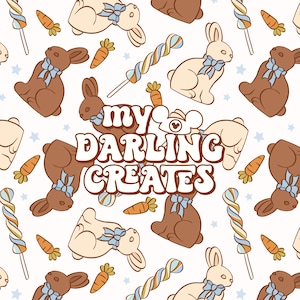 May include: A seamless pattern featuring chocolate and white bunny rabbits, candy canes, carrots, and stars on a white background. The text "my darling creates" is in the centre of the pattern.