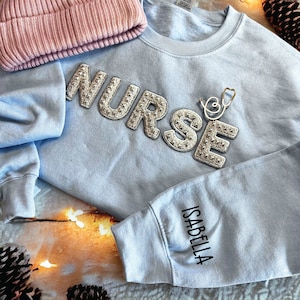 Custom Nurse Sweatshirt, Stethoscope Pin and name on the sleeve, Christmas Gift For Nurse, Nursing school, Nurse Graduation Gift, STUD805