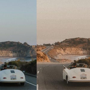 May include: A white vintage car driving on a winding road with a view of a beach and cliffs in the distance.