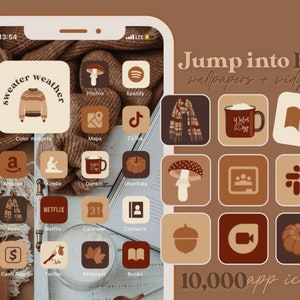May include: A phone screen with a fall-themed design. The background is a brown sweater. The icons are in a grid pattern and include apps like Spotify, TikTok, Amazon, Netflix, and more. The text "Jump into Fall wallpapers + widgets" and "10,000 app icons" are at the top and bottom of the screen.